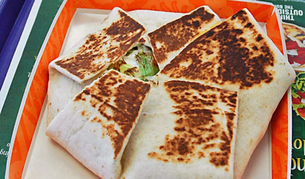 Grilled folded tortilla wrap with veggie filling.